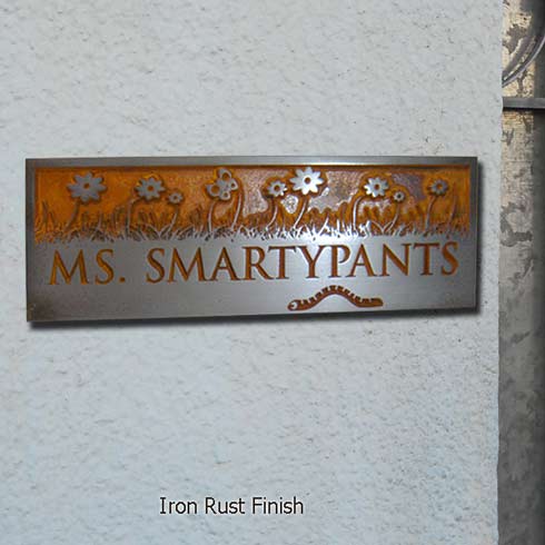photo of a floral motif name plate in Iron Rust finish